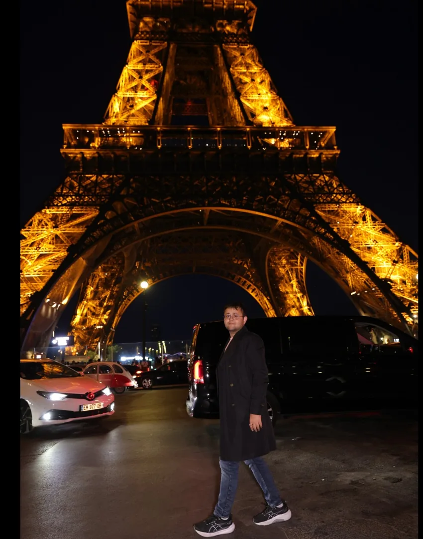 Kapil enjoying an evening near the illuminated Eiffel Tower