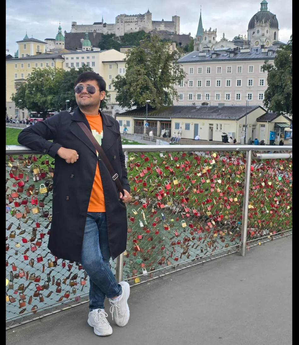 Kapil sightseeing in Salzburg beside the river and city skyline